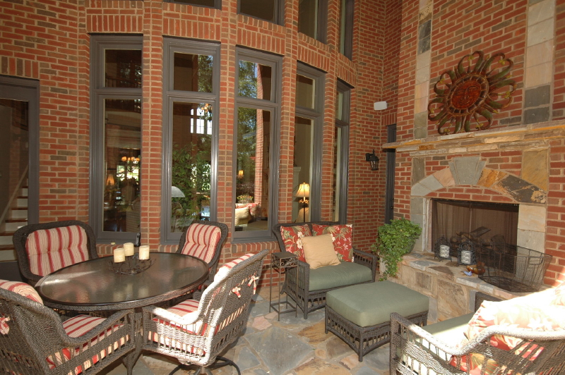 A deck remodel with outdoor fireplace and stone flooring