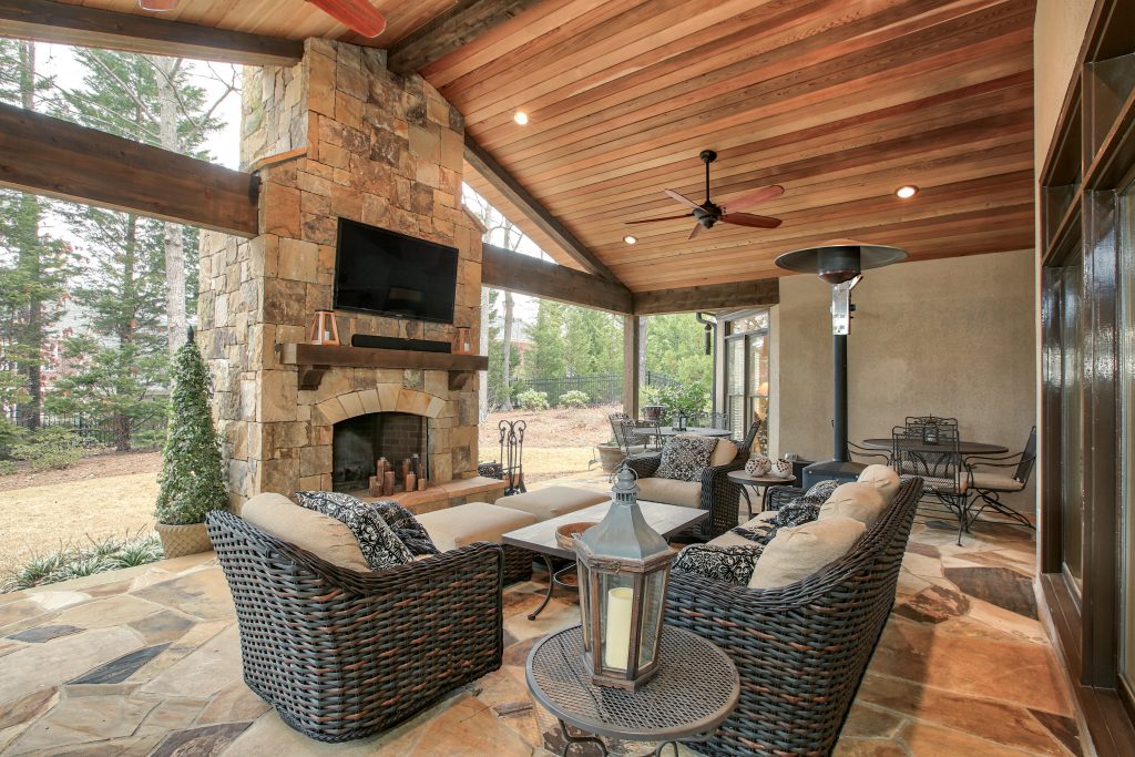 An covered porch/ patio renovation with outdoor fireplace