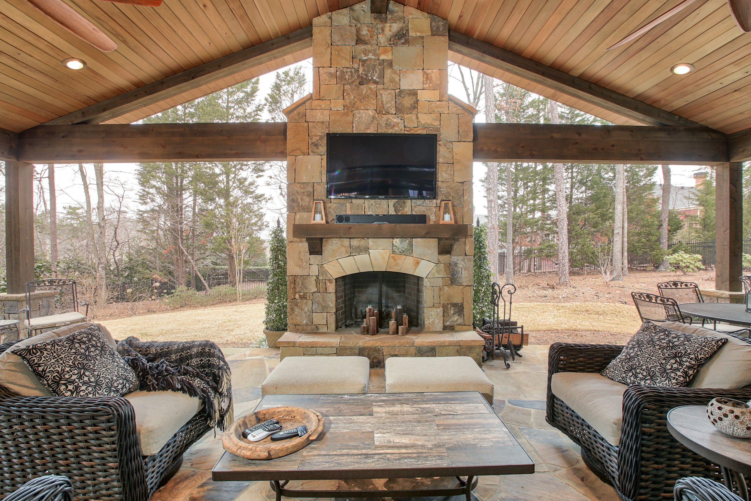 a new deck remodel with covered porch patio and outdoor fireplace