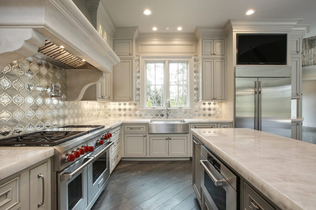A renovated kitchen featuring ornate backsplash