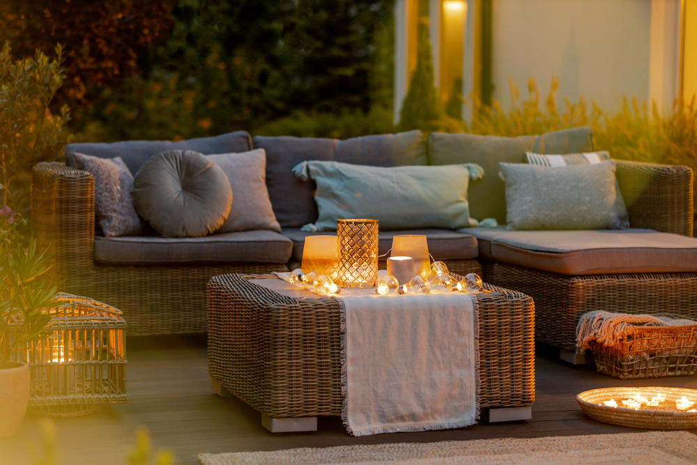 Summer patio with couch and candles ©Ground Picture